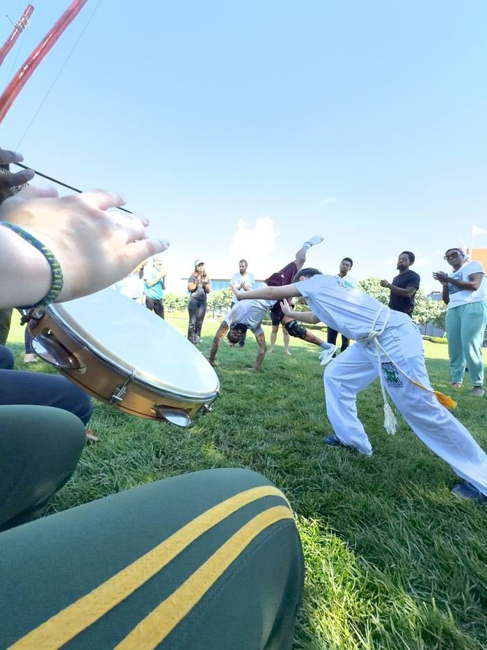 The outdoor roda on the grass, pandeiro in the foreground